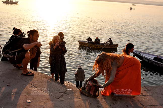 Travel- Varanasi the city of light (India) - A foreign devotee after taking bath in Holy River Ganges at Varanasi, Uttar Pradesh, India. by Anil