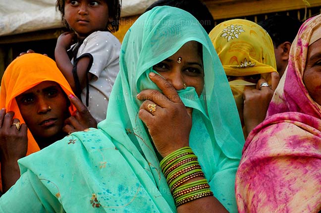 Festivals- Lathmaar Holi of Barsana (India) - A local women covering her face with her saree at Barsana, Mathura, Uttar Pradesh, India. by Anil