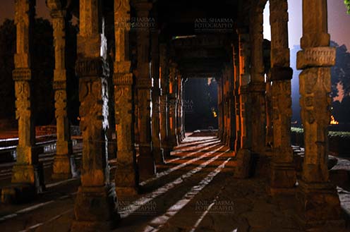 Monuments- Qutab Minar in Night, New Delhi, India. - The Beauty of Hindu Columns with stone carving at Quwwat-Ul-Islam mosque courtyard in night at Qutub Minar Complex, New Delhi, India. by Anil