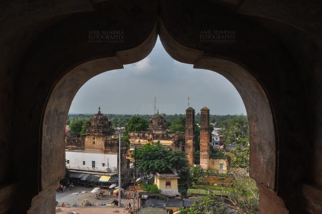 Monuments- Palaces and Temples of Orchha - Orchha, Madhya Pradesh, India- August 20, 2012: View from a carved window of Chaturbhuj temple, Orchha, Madhya Pradesh, India. by Anil