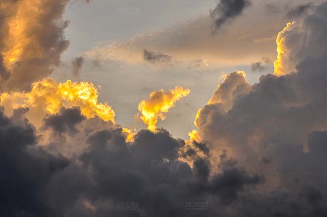 Clouds- Sky with Clouds (Uttarkashi) - Clouds over Uttarkashi Hills, Uttarakhand, India-  June 12, 2013: light Blue sky in the evening with yellow-orange color clouds over the hills of Uttarkashi, Uttarakhand, India. by Anil