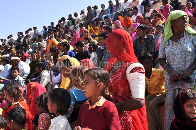 Festivals- Jaisalmer Desert Festival, Rajasthan - Local people enjoying women's matkaa race at Jaisalmer desert fair. by Anil
