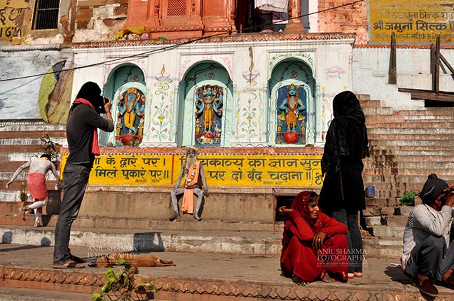 Travel- Varanasi the city of light (India) - A photographer taking picture of a Naga Sadhu at Varanasi, Uttar Pradesh, India. by Anil