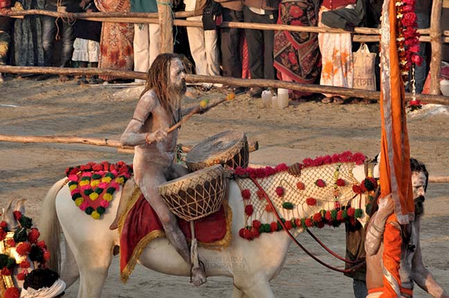 Religion- Naga Sadhu\u2019s at Mahakumbh (India) - Naga sadhu beating traditional drums at Mahakumbh, Allahabad, Uttar Pradesh, India. by Anil