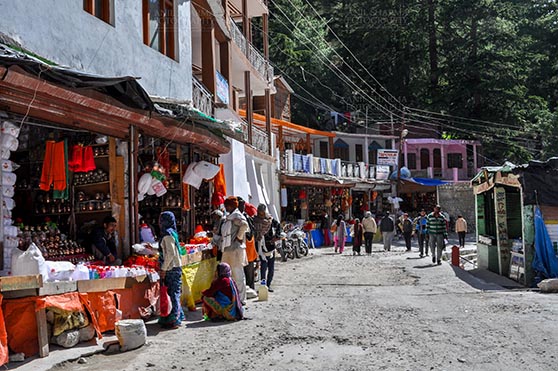 Travel- Gangotri (Uttarakhand) - Gangotri, Uttarakhand, India- May 13, 2015: Main Bazaar of Gangotri, tourists buying devotional objects from the shops Gangotri, Uttarkashi, Uttarakhand, India. by Anil