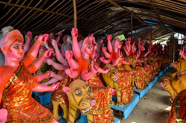Festivals- Durga Puja Festival - Durga Puja Festival, Noida, Uttar Pradesh, India- September 17, 2017: A row of Hindu Goddess Durga’s clay idol in a workshop in preparation for Durga Puja at Noida, Uttar Pradesh, India. by Anil