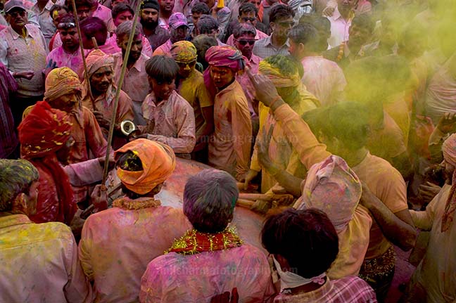 Festivals- Lathmaar Holi of Barsana (India) - Lagre number of people gathered sprinkle colored powder, singing, dancing during Lathmaar Holi celebration at Barsana, Mathura, India. by Anil