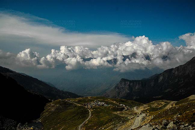 Clouds- Sky with Clouds (Rohtang La) - Clouds over Rohtan La, Himachal Pradesh, India-September 22, 2009: Snow covered mountain peaks with Dark blue sky and white clouds over Rohtang Pass, Himachal Pradesh, India. by Anil