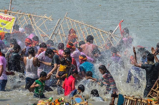 Festivals- Durga Puja Festival - Durga Puja Festival, New Delhi, India-September 30, 2017: Hindu devotees taking holy dip after immersing Goddess Durga idol into river Yamuna at Kalindi Kunj, New Delhi, India. by Anil