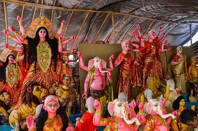 Festivals- Durga Puja Festival - Durga Puja Festival, Noida, Uttar Pradesh, India- September 20, 2017: A row of Hindu God Lord Ganesha and Goddess Durga in a workshop at Noida, Uttar Pradesh, India. by Anil
