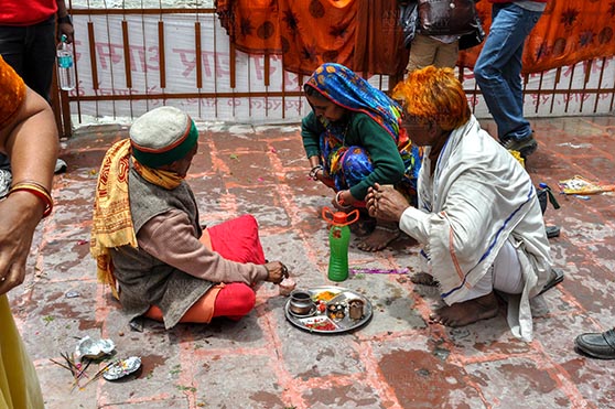 Travel- Gangotri (Uttarakhand) - Gangotri, Uttarakhand, India- June 14, 2013: A Hindu family making a religious ritual at Goddess Ganga Temple, Gangotri, Uttarakhand, India. by Anil