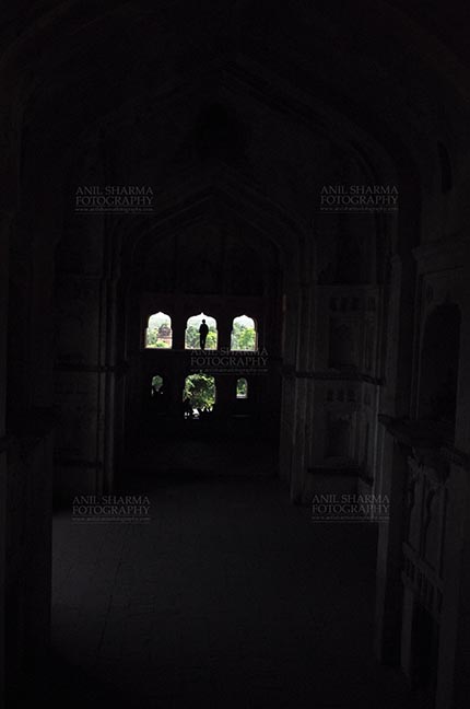 Monuments- Palaces and Temples of Orchha - Orchha, Madhya Pradesh, India- August 20, 2012: Silhouette of a woman in Chaturbhuj Temple at Orchha, Madhya Pradesh, India. by Anil