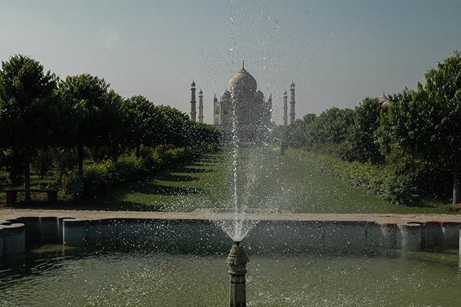 Monuments- Taj Mahal, Agra (India) - Fountain at Taj Mahal complex with Taj Mahal in the background at Agra, Uttar Pradesh, India. by Anil