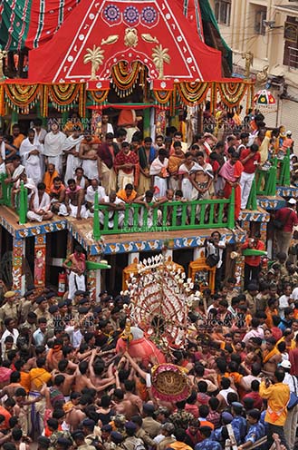 Festivals- Jagannath Rath Yatra (Odisha) - Deity of Balbhadra being taken to the chariot on the occasion of Rath Yatra at Puri, Odisha, India. by Anil