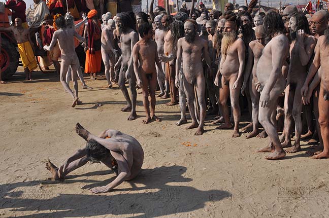Religion- Naga Sadhu\u2019s at Mahakumbh (India) - Naga sadhu performing yoga near camp at Mahakumbh Allahabad, Uttar Pradesh, India. by Anil