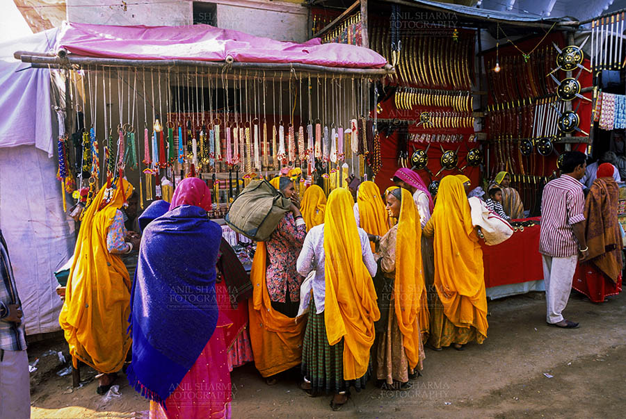 Fairs- Pushkar Fair (Rajasthan) - Pushkar, Rajasthan, India- May 23, 2008: Devotees buying Bangels from a shop at Pushkar fair, Rajasthan, India. by Anil