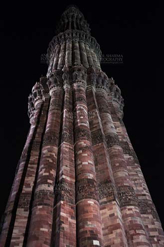 Monuments- Qutab Minar in Night, New Delhi, India. - Qutab Minar with Architecure details and verses from Holy Quran at Qutab Minar Complex, New Delhi, India. by Anil