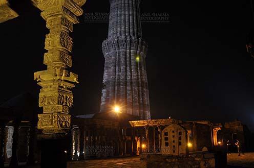 Monuments- Qutab Minar in Night, New Delhi, India. - An ornately carved pillar at the Quwwat-Ul-Islam mosque in night at Qutub Minar Complex, Mehrauli , New Delhi, India. by Anil