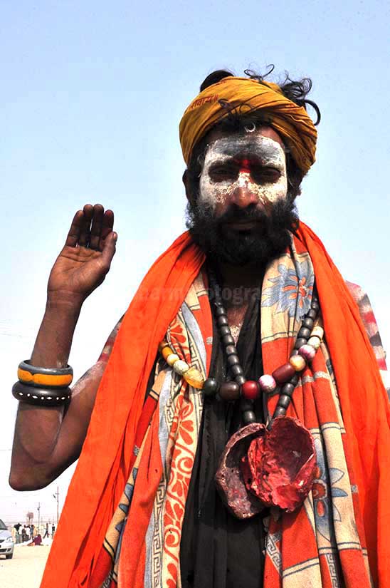 Culture- Aghori Sadhu, Uttar Pradesh (India). - Aghori Sadhu with long hairs, ash on the face, wearing human bones and rudraksha bead at Mahakumbh Allahabad. by Anil
