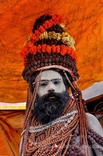 Naga Sadhu with headdress of Rudraksha bead and marigold malas at Varanasi.