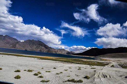 Clouds over Pangong Tso, Leh, Jammu and Kashmir, India- October 1, 2014: Dark blue sky with Bright white clouds over the Pangong Tso and surrounding hills at Leh, Jammu and Kashmir, India.