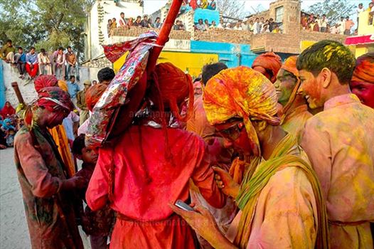 Local people daubed in color powder during Lathmaar Holi celebration at Barsana, Mathura, Uttar Pradesh, India.