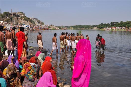 Baneshwar, Dungarpur, Rajasthan, India- February 14, 2011: Devotees ready for the traditional ritual bath at the confluence of the rivers, Mahi and Som at Baneshwar, Dungarpur, Rajasthan, India