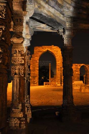 Qutab Minar, Mehrauli, New Delhi, India- October 25, 2010: Beauty of arches of  Iltutmish screen and iron pillar in night at Qutub Minar Complex, Mehrauli , New Delhi, India.