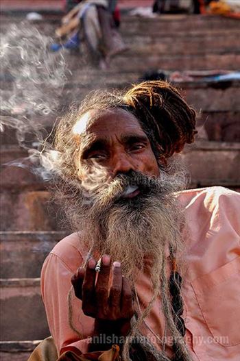 A Naga Sadhu smoking  bidi at Varanasi ghat.