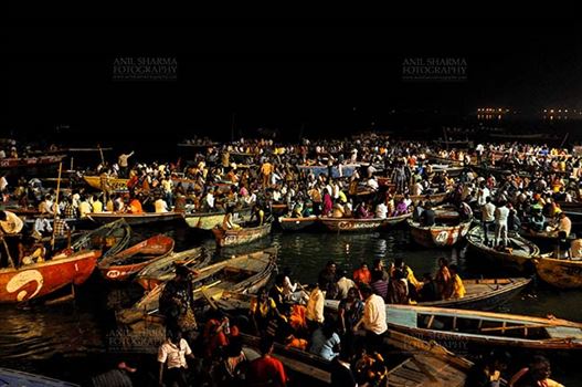 Large number of devotees in boats admiring aarti at Dasashwamedh Ghats in late evening at Varanasi. Uttar Pradesh, India.