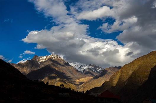 Clouds, Jispa, Himachal Pradesh, India- September 24, 2014: Dark blue sky with white clouds floating over the snow covered mountain peaks at Jispa Village, Lahaul-Spiti, Himachal Pradesh, India.