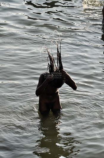 A Naga Sadhu taking ritual bath in Ganges River at Varanasi, Uttar Pradesh, India.