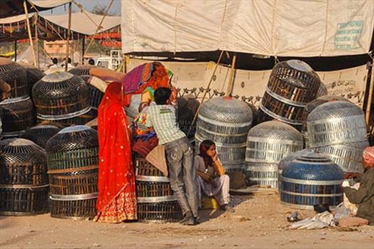 Nagaur, Rajasthan, India- Febuary 10, 2011: A Rajasthani family selling metal baskets to store utensils at Nagaur cattle fair, Nagaur, Rajasthan (India).
