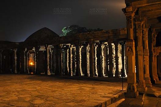 The beauty of Hindu temple columns with stone carving in the courtyard of Quwwat-Ul-Islam mosque in night at Qutub Minar Complex, Mehrauli , New Delhi, India.